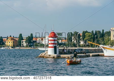 Zadar, Croatia - Aug 13, 2020: Lighthouse In City Harbour In Afternoon
