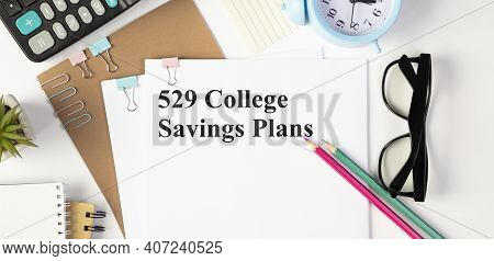 On The Table Are Financial Reports, A Pen, A Magnifying Glass And A Notebook With The Inscription - 
