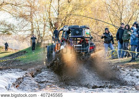Afipsip, Russia - October 31, 2020: Sportsman On Buggy Drives Splashing In Water At Mud Racing Conte