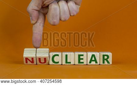 Nuclear Or Clear Symbol. Businessman Turns A Cube And Changes The Word 'nuclear' To 'clear'. Beautif