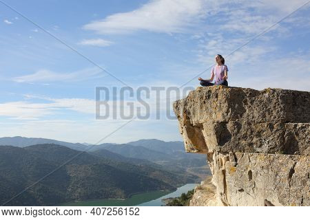 Yogi Doing Yoga Exercise Meditating In The Top Of Cliff In The Mountain With A Beautiful Landscape I