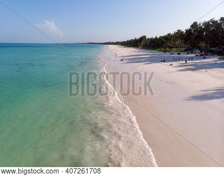 Tropical Beach With White Sand Bordered With Torquoise Ocean In Zanzibar, Paje Beach. Tanzania