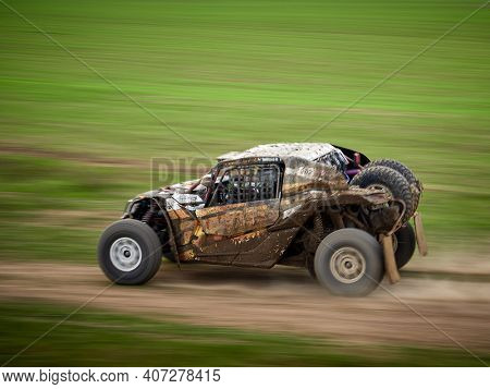 Constanta, Romania - August 21, 2020: 4x4 cars competing for leadership at the 4V Rally Raid, dinamic image of car speeding on the green field 