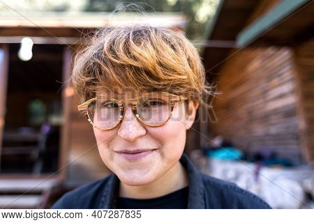 Portrait Of A Young Girl In Vintage Glasses. Young Girl Smiles. Hipster Style. Lgbd. Wooden Glasses