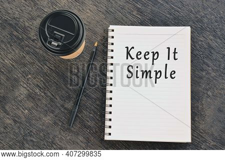 Keep It Simple Text On Notepad With Disposable Coffee Cup And Pen On Wooden Table