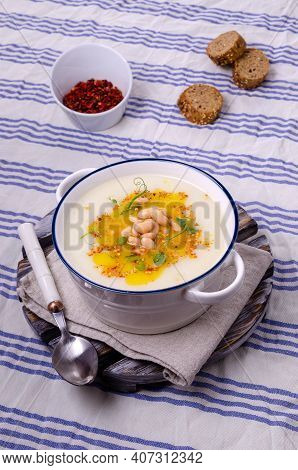 Vegetable Cream Soup With Beans And Spicy Oil In A Bowl On A Textile Background. Selective Focus.