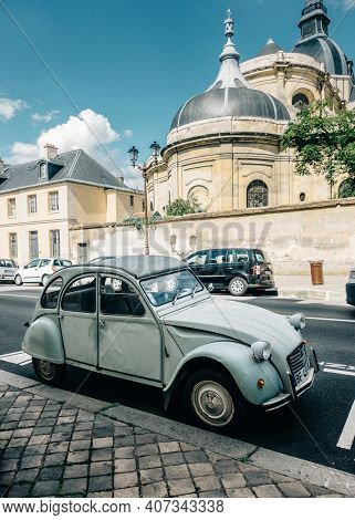 VERSAILLES, FRANCE - CIRCA SEPTEMBER 2015: A Citroen 2CV parked in the street, church in the background.