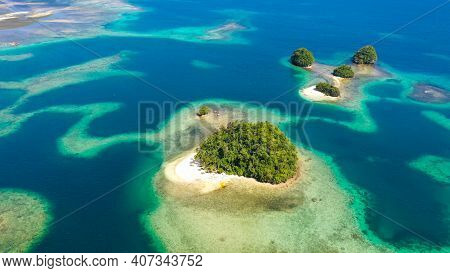 Top View Of Small Tropical Island In The Blue Sea With A Coral Reef And The Beach. Britania Islands,