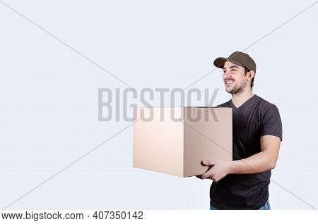 Image Of A Happy Young Delivery Man  With Parcel Post Box Isolated Over White Background. Courier De