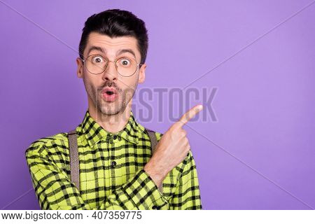 Portrait Of Young Shocked Surprised Amazed Man In Glasses Pointing Finger Copyspace Isolated On Viol