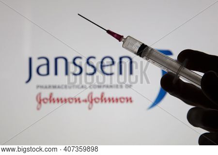 Oxford, Uk - February 2020: A Covid Vaccine Syringe Against The Janssen Logo