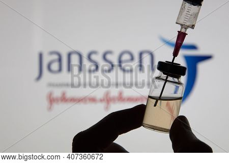 Oxford, Uk - February 2020: A Covid Vaccine Syringe Against The Janssen Logo
