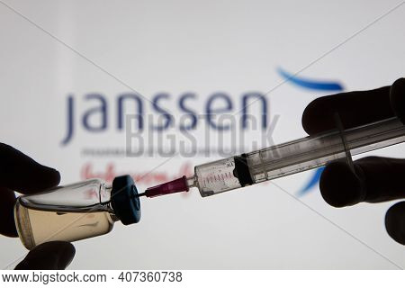 Oxford, Uk - February 2020: A Covid Vaccine Syringe Against The Janssen Logo