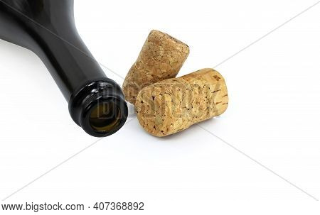 Wine Bottle And Wine Corks Isolated On White Background As Symbol Of Excessive Alcohol Consumption A