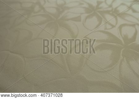 Closeup Of Glossy Cream Colored Polyamide Fabric With Floral Pattern
