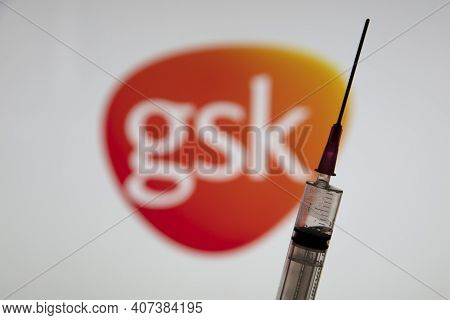 Oxford, Uk - February 2020: Glaxosmithkline Logo With A Covid Vaccine Syringe