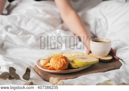 Having A Breakfast In Bed From A Tray With Fruits And Tea In White Clean Bed. Mindful And Quiet Livi