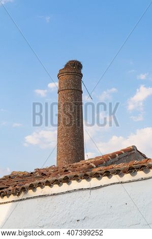 Old Chimney Of An Abandoned Factory In Southern Spain, With A Nice Blue Sky