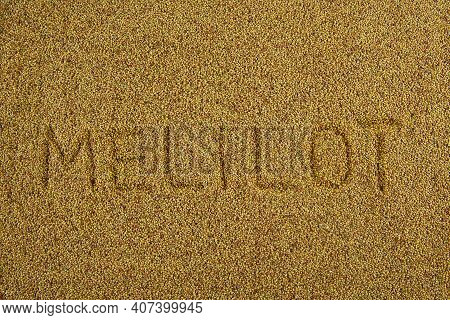 Background From Sweet Clover Seeds With The Inscription Melilot. Honey Plant