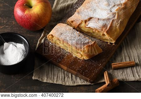 Arrangement of pple strudel with utensils and ingredients