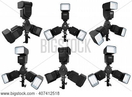 3 Speedlight Flashes Guns On Tripod Holder Isolated On White Background With Clipping Path. 3d Rende