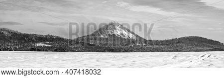 Winter Hilly Landscape Of Lusatian Mountains With Klic Mountain In The Middle. Czech Republic. Black