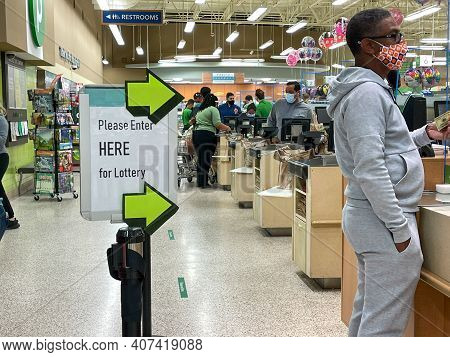 People Waiting In Line To Purchase Lottery Tickets At A Publix Grocery Store