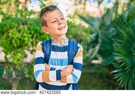 dorable caucasian student boy smiling happy standing at the park.