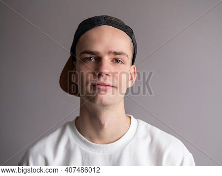 Portrait Of A Handsome Young Man, A Teenager In A Cap