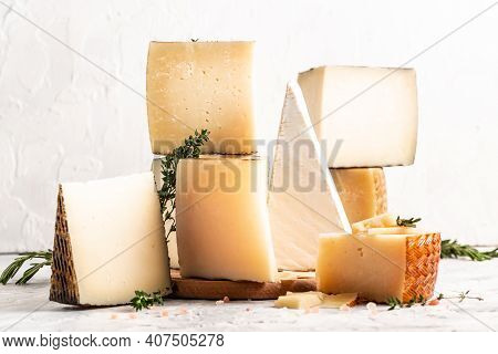 Spanish Manchego Cheese, Various Types Of Cheese On A Light Background, Place For Text.