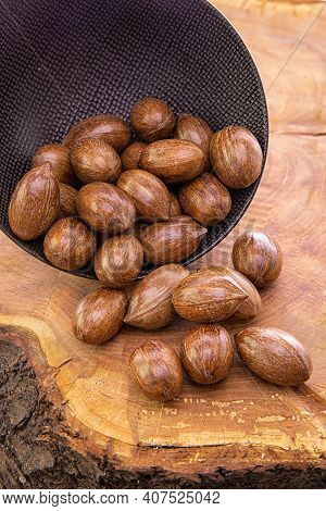 Pecann Sse Fall From The Dark Cup On Wooden Background