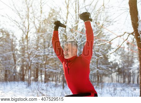 Outdoor Functional Training Concept. Healthy Mature Man Using Suspension Straps To Exercise Upper Bo