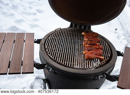 Winter Bbq In The Fresh White Snow, Men Grilling Chicken Wings In The Winter Onn Grill