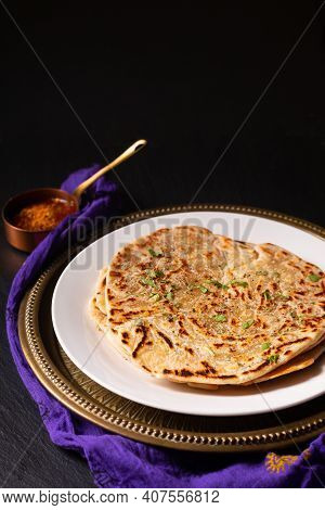 Food Concept Spot Focus Homemade Paratha, Parotta Or Porotta Layered Flatbread  On Black Background