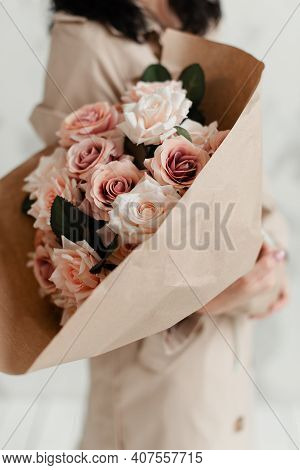 The Florist Holds In Her Hands A Beautiful Colorful Bouquet Of Decorative Flowers Made Of Pink Roses