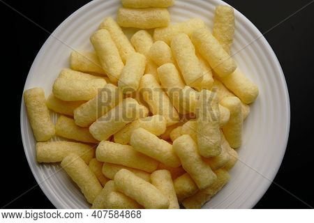 Corn Sweet Sticks On A White Plate Top View. Golden Color.
