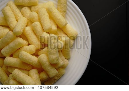 Corn Sweet Sticks On A White Plate Top View. Golden Color.