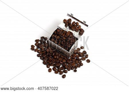 Roasted Coffee Beans In A Small Metal Chest Around It. Isolate On A White Background. Copspace