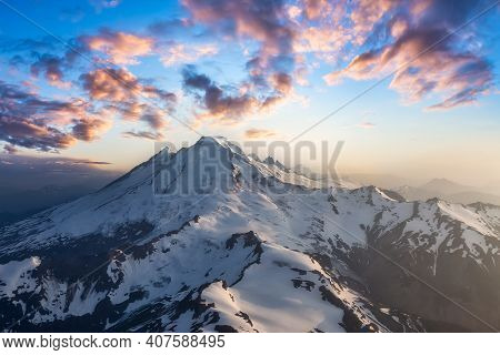 Dramatic Aerial Landscape View Of The Cloud Covered Mountains During A Vibrant Sunset. Artistic Rend