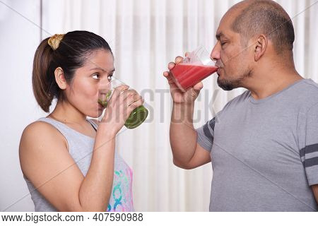 Green Smoothie With Focused Kiwis And Woman Exercising On Unfocused Background