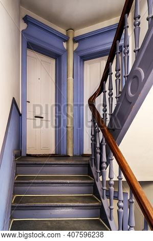 Wooden Ancient Spiral Staircase With Apartments Doors In An Old Building. Old Residential Buildingr 
