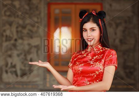 Beautiful Asian Woman In Red Chinese Dress Traditional Cheongsam Qipao With Gesture Of Introduce Or 