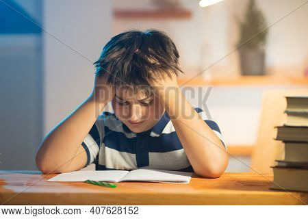 Learning Difficulty Idea. The Child Ruffled The Hair On The Head The Tension Is Visible On The Face.