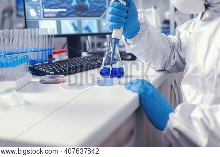 Medicine Scientist Pouring Liquid On Petri Dish Working In Lab With Micropipette. Chemist In Modern 