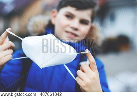 Kid Boy Wearing Ffp Medical Mask On The Way To School. Child Backpack Satchel. Schoolkid On Cold Aut