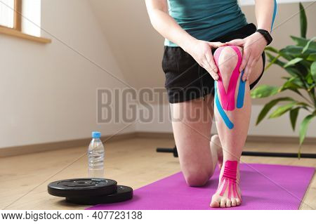 Kinesiotaping, Kinesiology. Female Athlete With Kinesiotape, Muscle Tape On Knee. Wourkout At Home.