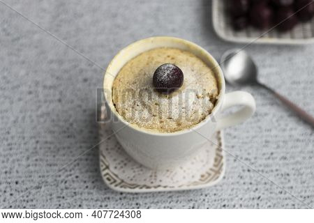 Vanilla Cupcake With Cherries In A Mug. Delicious Sweet Dessert