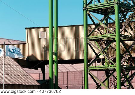 Container Terminal Of Tis Group Ukraine Largest Dry Cargo Port. Metal Tower Stairs Painted In Green 