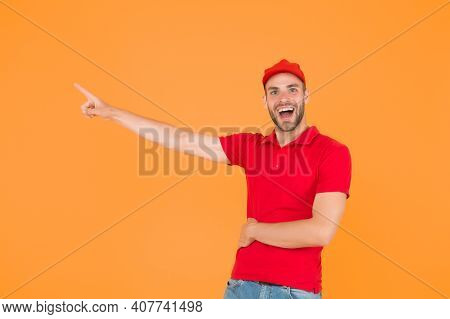 Delivery Concept. Portrait Of Smiling Deliveryman. Shows Away. Mail Service, Job And People Concept.