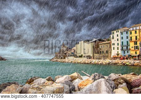 Rain couldy storm on Portovenere (Porto Venere) in Liguria, Italy: scenic view of the Church of St. Peter (Chiesa di San Pietro) from coast